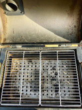 Load image into Gallery viewer, Two Que-Tensils Stainless Steel Half Grill Plates sitting in the Oklahoma Joe Rambler barbecue.