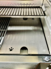 Load image into Gallery viewer, An image of the Que-Tensils Half Hot Plate for the Masterbuilt 560 sitting in the BBQ
