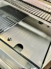 Load image into Gallery viewer, An image of the Que-Tensils Half Hot Plate for the Masterbuilt 560 sitting in the BBQ
