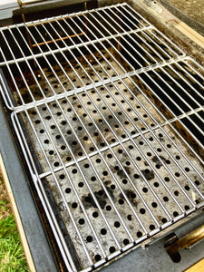 Two Que-Tensils Stainless Steel Half Grill Plates sitting in the Oklahoma Joe Rambler barbecue.